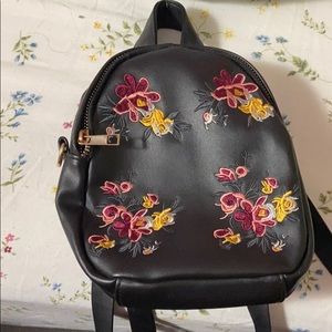 black mini back pack with flower detail